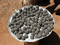 A dish holds balls of soumbala in its final, ready-to-use form. Photo by Christian Costeaux.